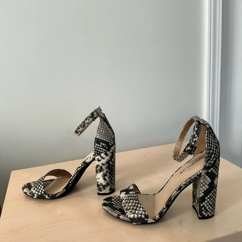 Francesca’s snake print embossed ankle strap heels